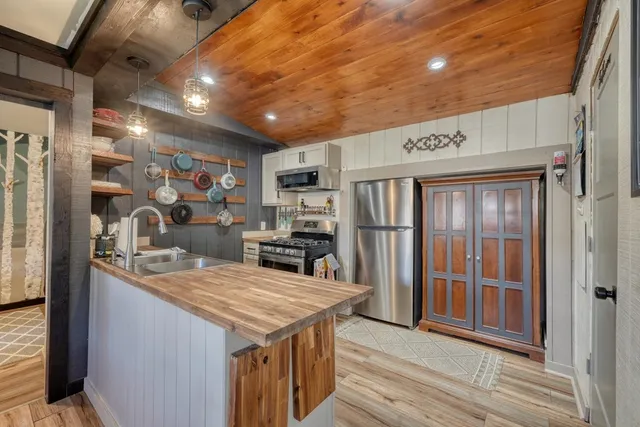 a kitchen with stainless steel appliances granite countertop a sink and cabinets