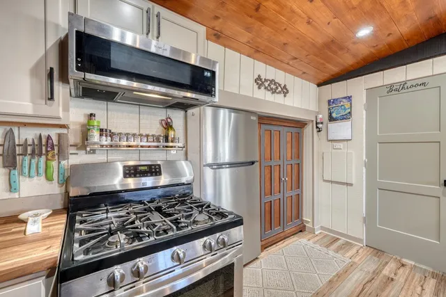 a kitchen with stainless steel appliances granite countertop a stove and a refrigerator