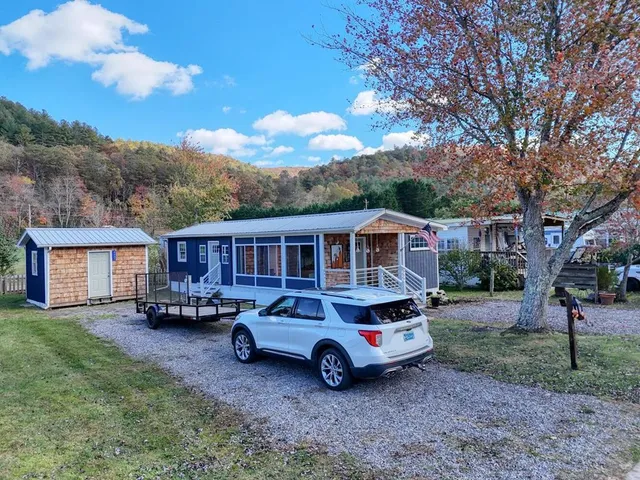 a car parked in front of a house with a yard