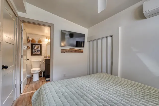 a bedroom with a bed and a view of bathroom