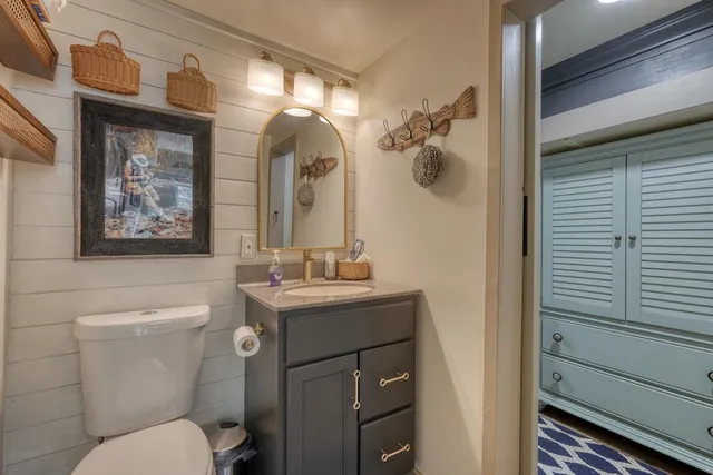 a bathroom with a toilet a sink and mirror