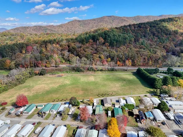 an aerial view of a houses with a lake view