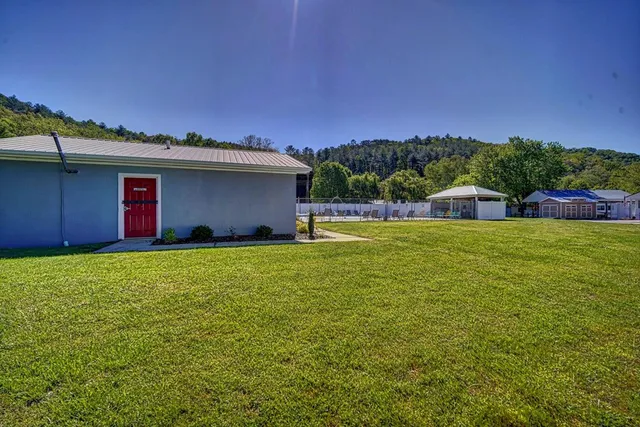 a house view with swimming pool in front of it