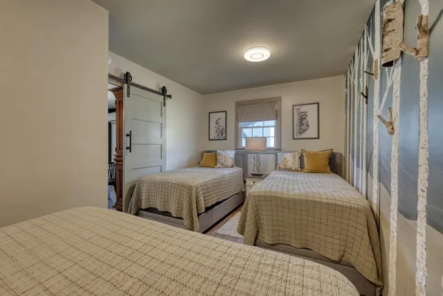 a bedroom with double bed and a window