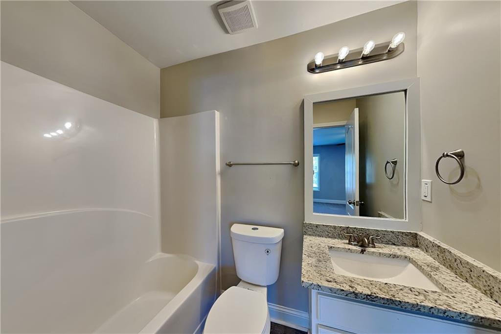 227 Brightondale Boulevard Dallas, GA 30132 - Photo 15 of 26 a bathroom with a granite countertop sink toilet and shower