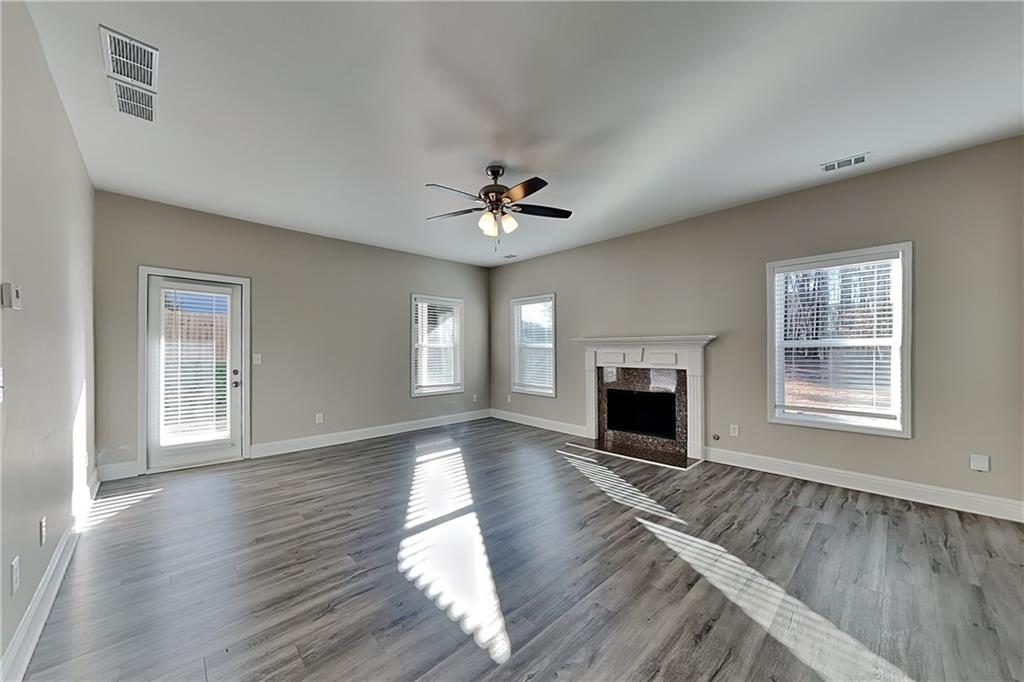 227 Brightondale Boulevard Dallas, GA 30132 - Photo 2 of 26 wooden floor fireplace and windows in an empty room