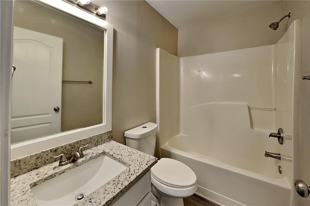 227 Brightondale Boulevard Dallas, GA 30132 - Photo 22 of 26 a bathroom with a granite countertop sink toilet mirror and shower