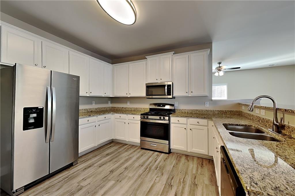 227 Brightondale Boulevard Dallas, GA 30132 - Photo 6 of 26 a kitchen with granite countertop white cabinets and stainless steel appliances