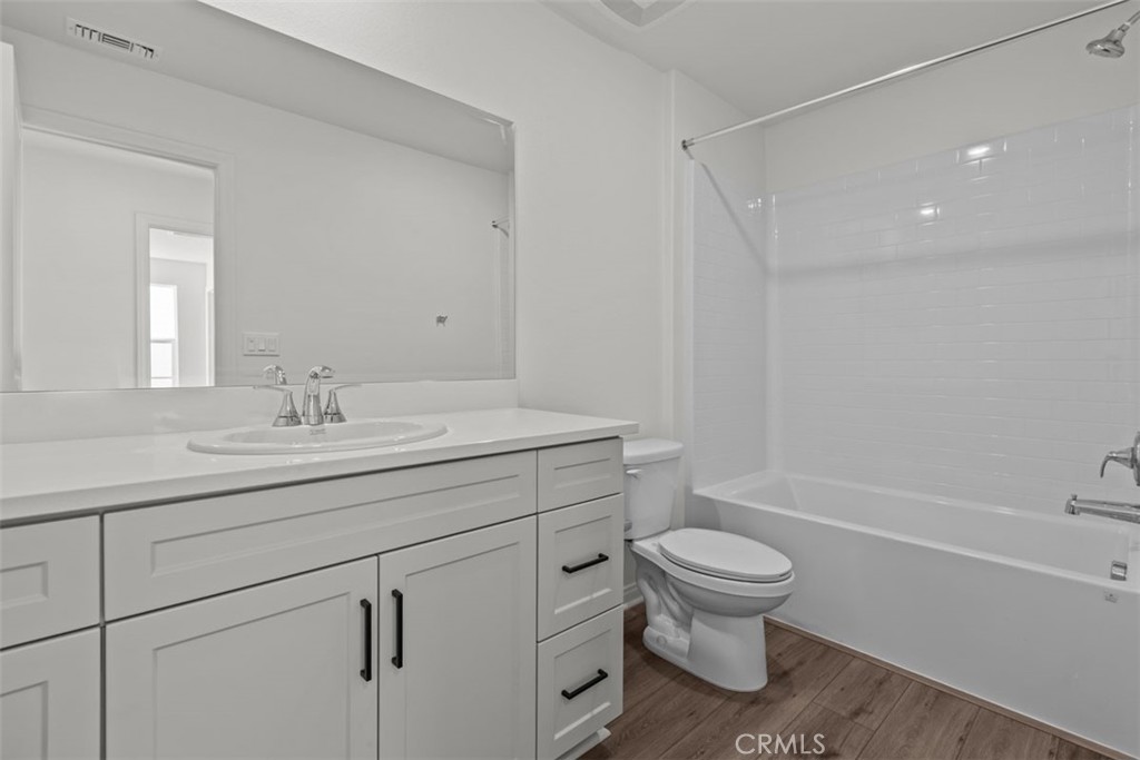 1213 Butterfly Way Banning, CA 92220 - Photo 15 of 18 a bathroom with a sink a toilet and a mirror