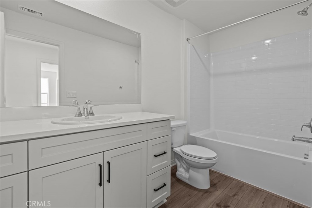 1213 Butterfly Way Banning, CA 92220 - Photo 15 of 18 a bathroom with a sink a toilet and a mirror