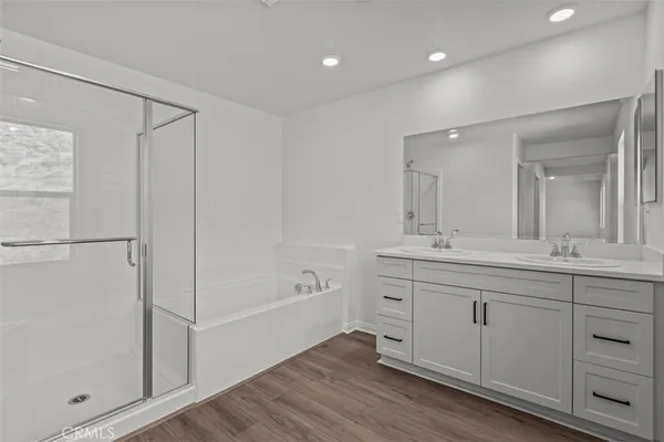 a spacious bathroom with a shower a sink and a mirror
