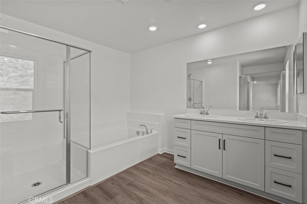 1213 Butterfly Way Banning, CA 92220 - Photo 18 of 18 a spacious bathroom with a shower a sink and a mirror