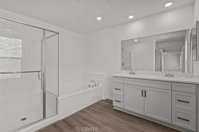 a spacious bathroom with a shower a sink and a mirror