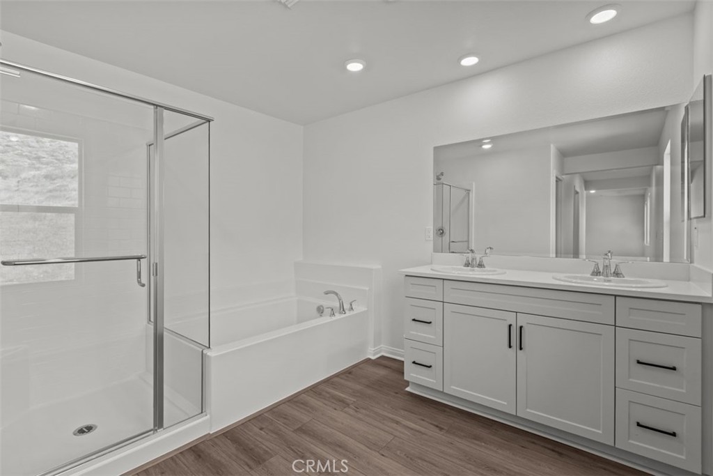 1213 Butterfly Way Banning, CA 92220 - Photo 18 of 18 a spacious bathroom with a shower a sink and a mirror