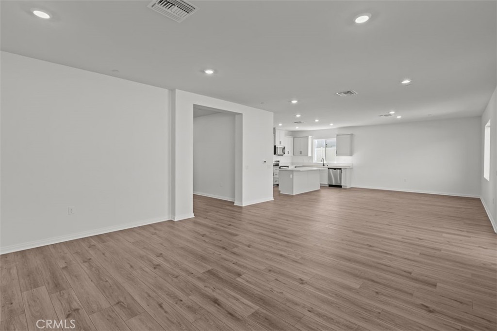 1213 Butterfly Way Banning, CA 92220 - Photo 3 of 18 a view of empty room with wooden floor