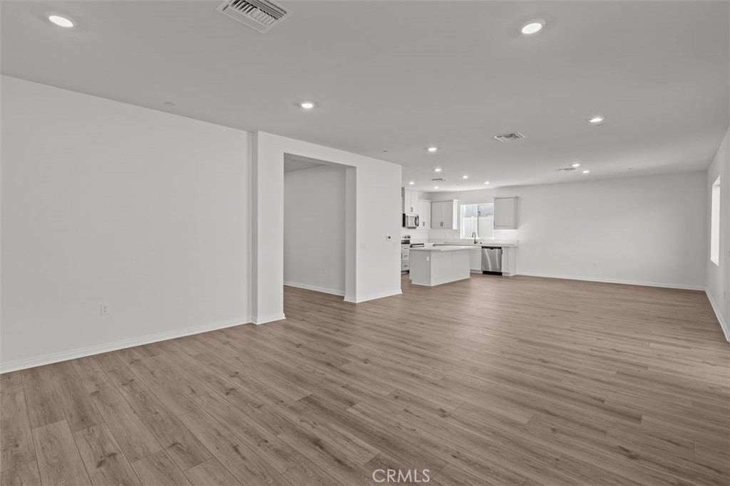 1213 Butterfly Way Banning, CA 92220 - Photo 3 of 18 a view of empty room with wooden floor