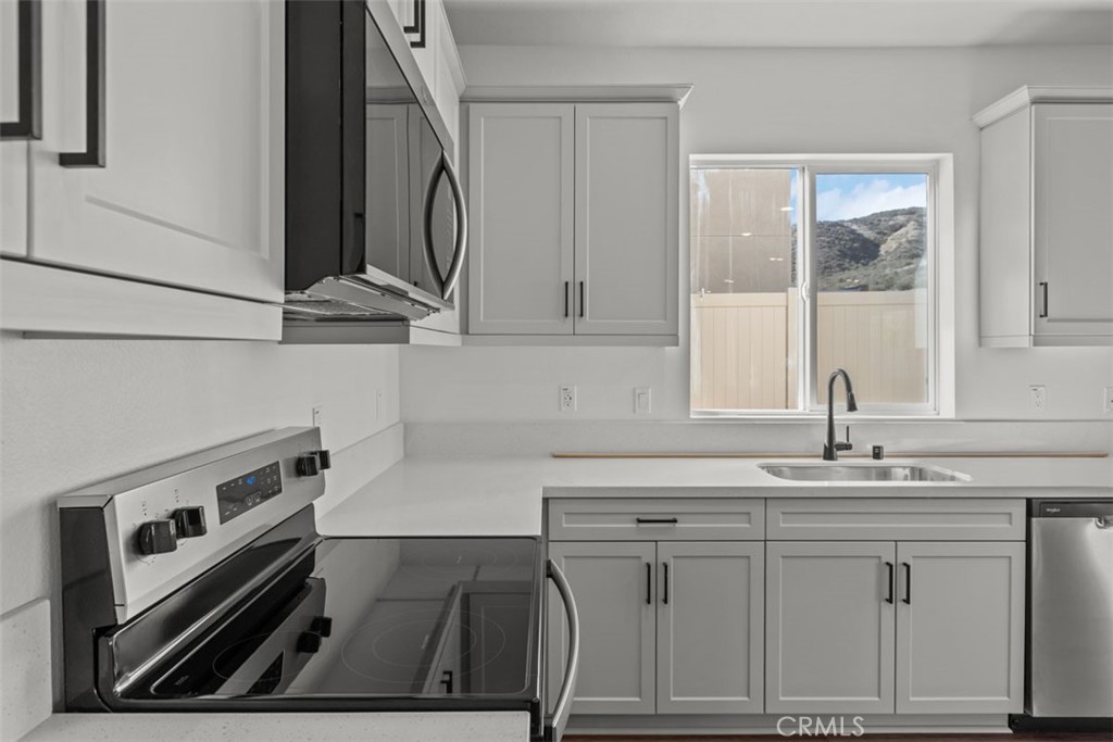 1213 Butterfly Way Banning, CA 92220 - Photo 6 of 18 a kitchen with white cabinets and sink