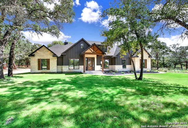 233 Timber Place La Vernia, TX 78121 - Photo 1 of 1 a front view of a house with a garden and trees