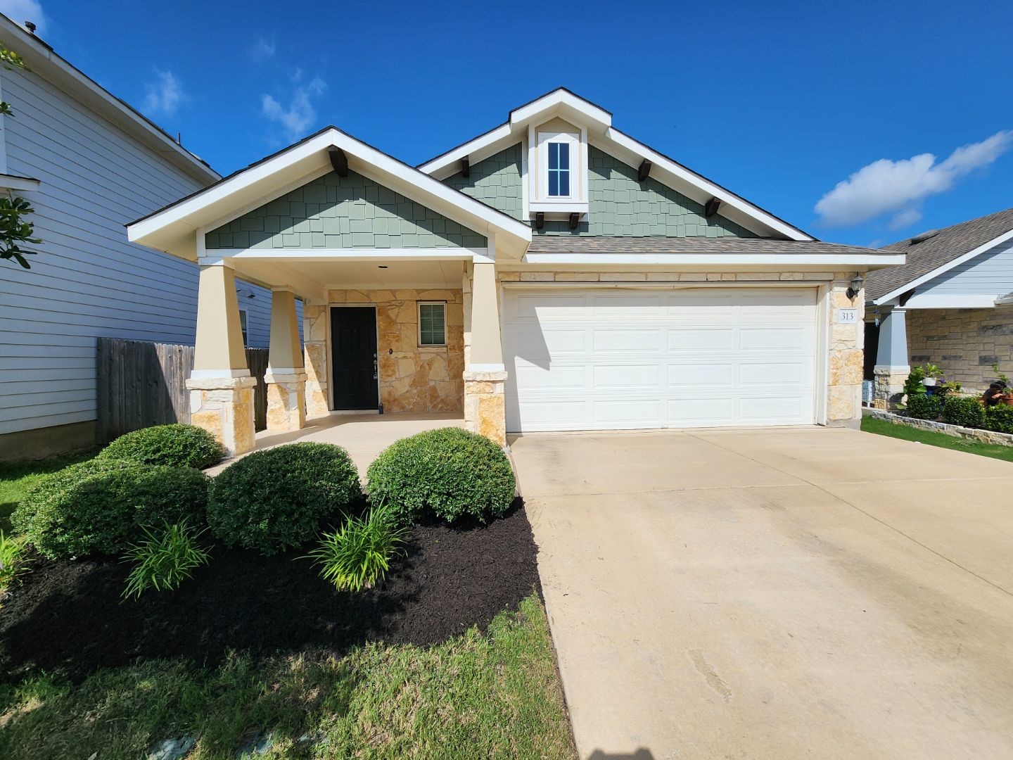 313 Gaida Loop Georgetown, TX 78628 - Photo 20 of 20 A welcoming facade presents a harmonious blend of stone accents and a covered entryway.