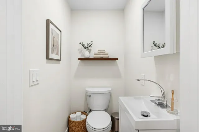 a bathroom with a toilet sink and mirror