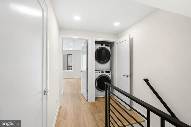 a view of a hallway with washer and dryer