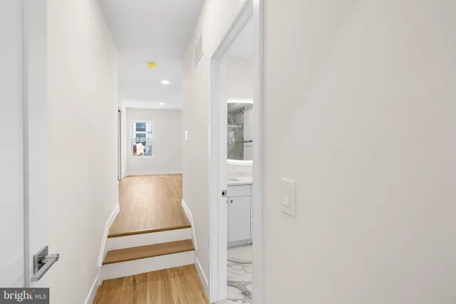 an entryway of a house with wooden floor