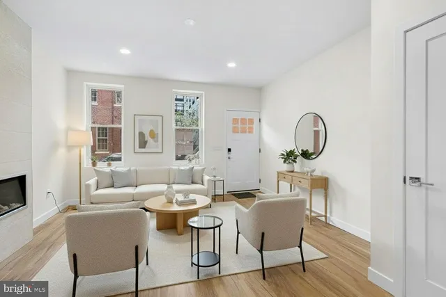 a view of a dining room with furniture a rug and wooden floor