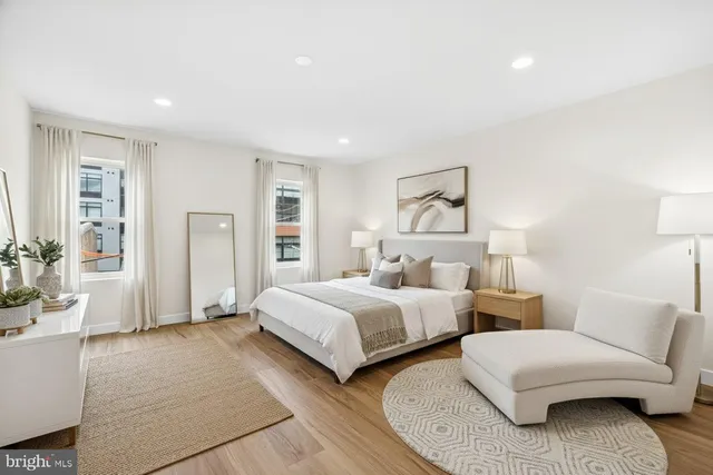 a spacious bedroom with two beds and painted walls