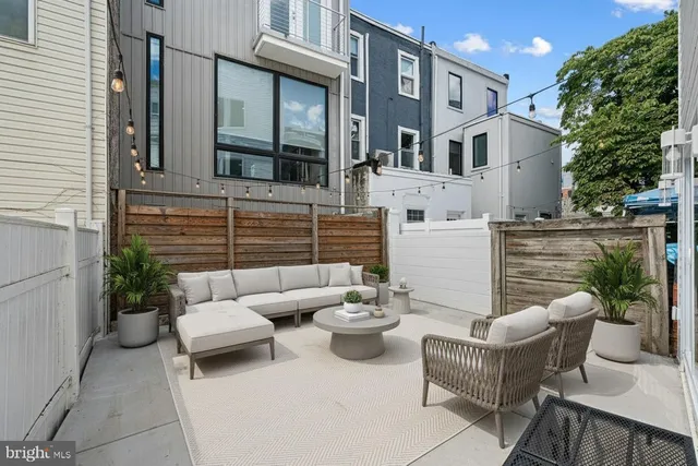 a view of a patio with couches and potted plants