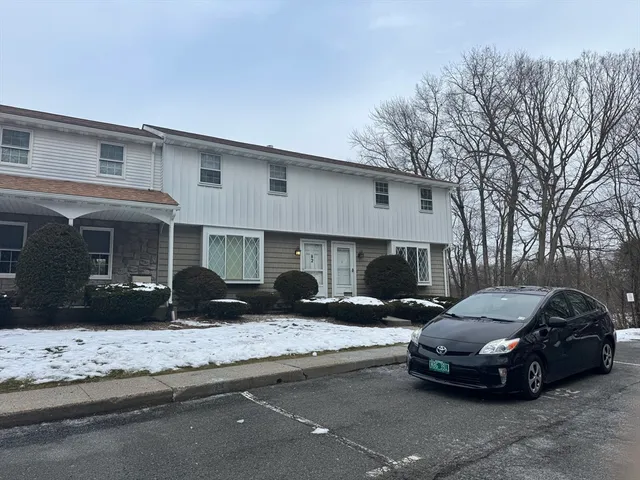a view of a car parked front of a house