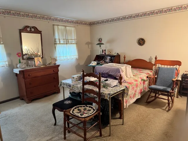 a bedroom with furniture and a window