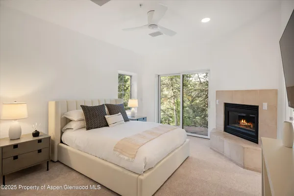 a bedroom with a bed and a fireplace