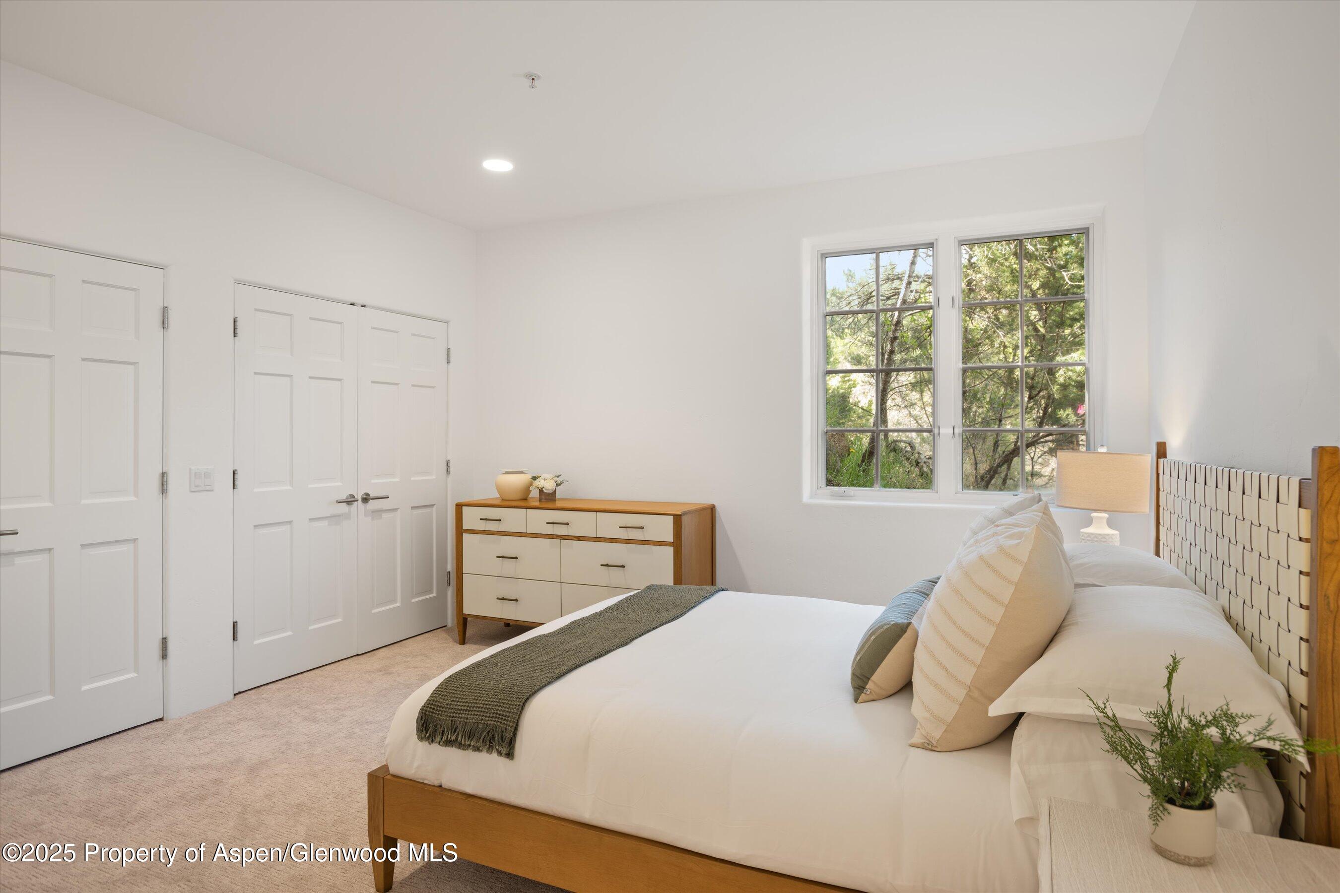 302 Wild Spring Lane Basalt, CO 81621 - Photo 14 of 28 a bedroom with a bed and wooden floor