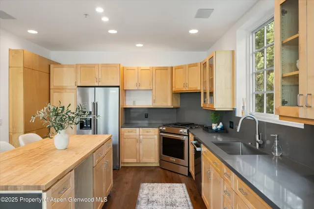 a kitchen with a sink a counter top space and appliances