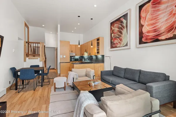 a living room with furniture and kitchen view