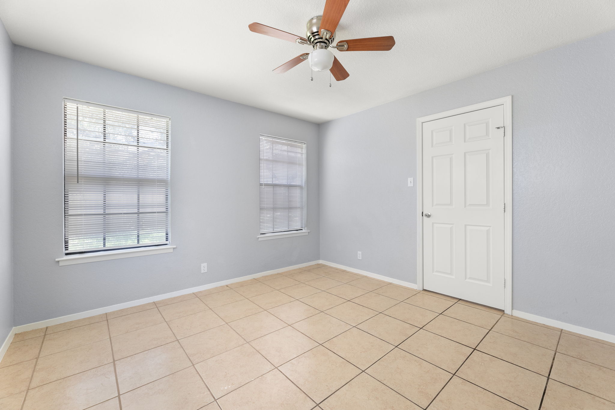 3802 Foust Trail, Unit A Georgetown, TX 78628 - Photo 15 of 34 Functional bedroom space with tiled flooring and ample natural light through multiple windows.