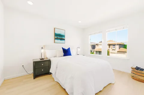 a spacious bedroom with a bed and a window