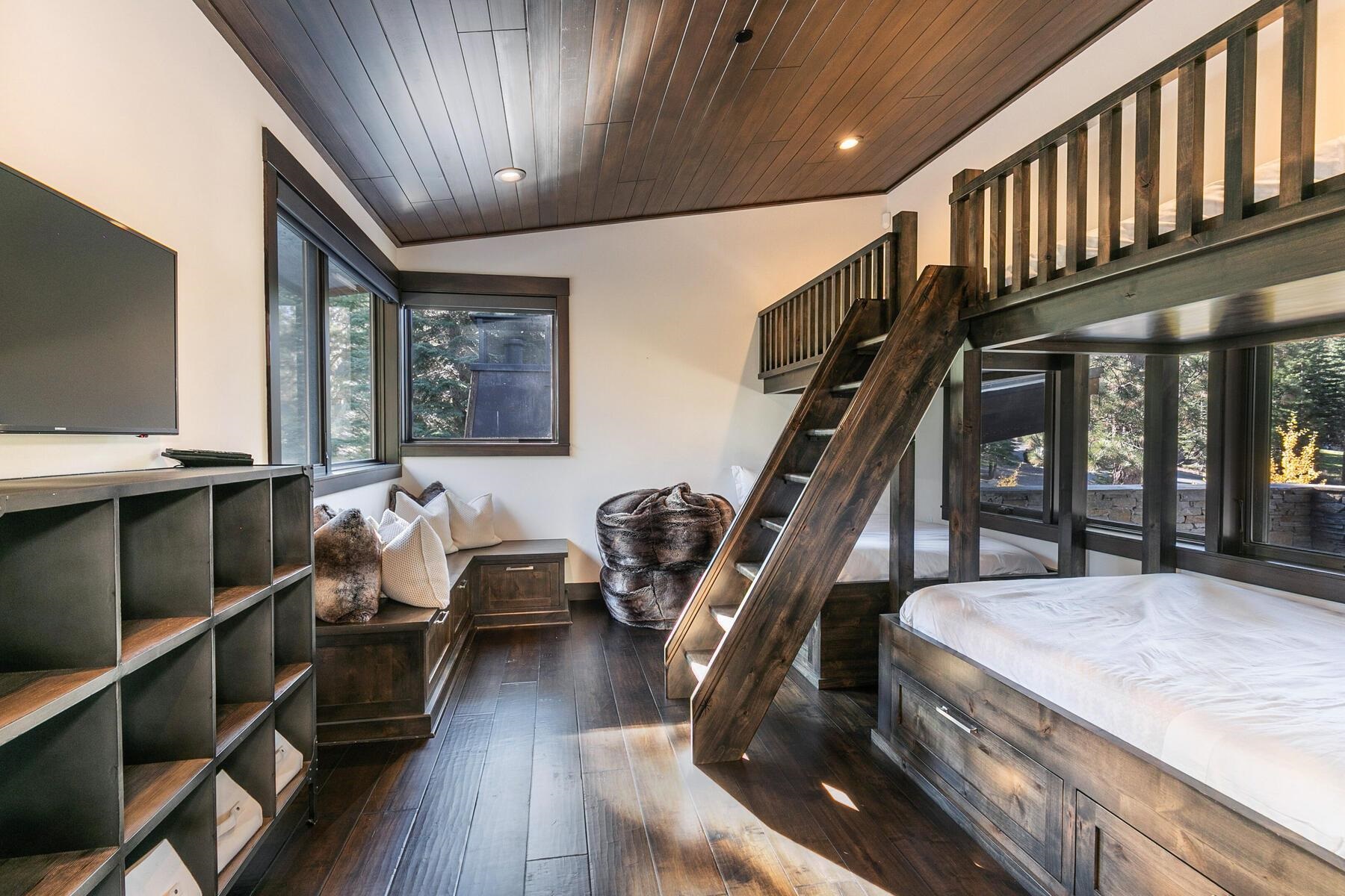 10617 Carson Range Road Truckee, CA 96161 - Photo 18 of 21 a living room with furniture stairs and a flat screen tv