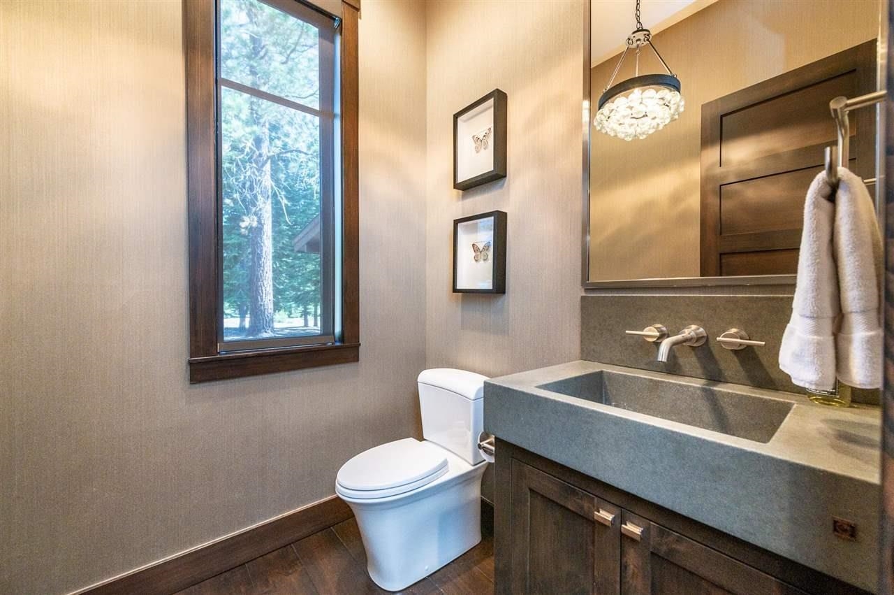 10617 Carson Range Road Truckee, CA 96161 - Photo 19 of 21 a bathroom with a sink a toilet and a large mirror