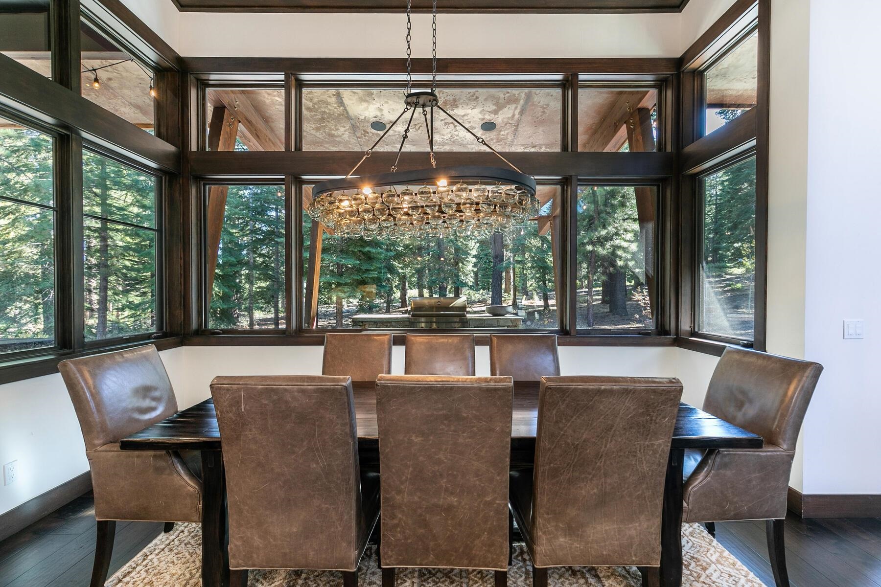 10617 Carson Range Road Truckee, CA 96161 - Photo 5 of 21 a view of a dining room with furniture large windows and a chandelier