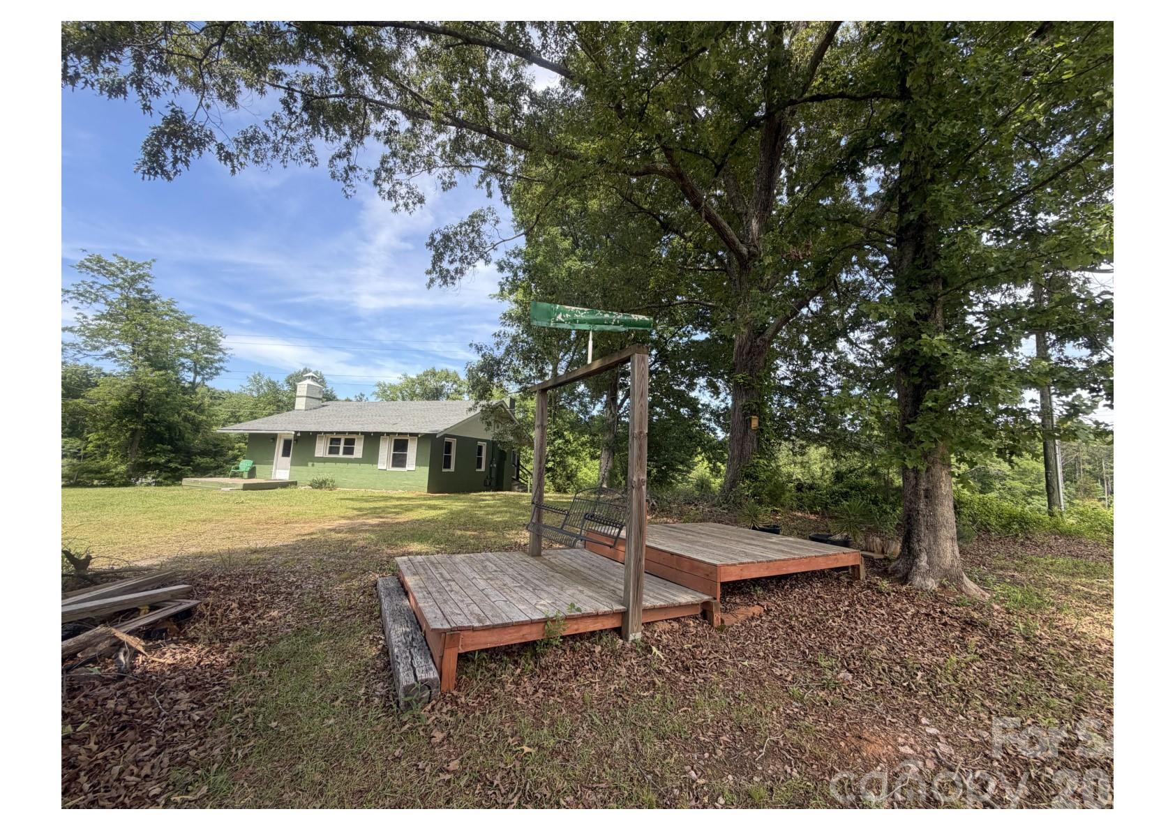 341 Lake Road Rockingham, NC 28379 - Photo 21 of 25 a view of a house with backyard and a tree