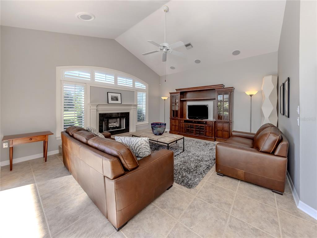 406 Trenwick Lane Venice, FL 34293 - Photo 14 of 60 a living room with furniture and a fireplace