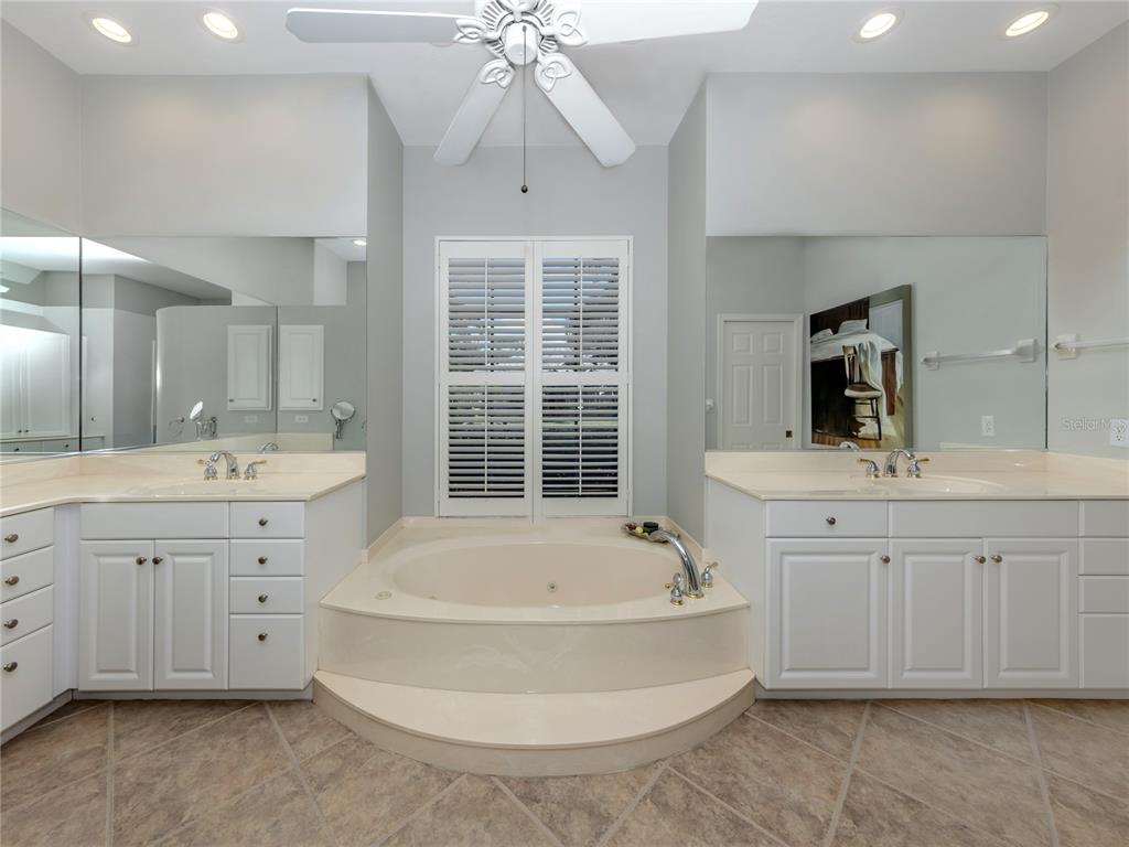 406 Trenwick Lane Venice, FL 34293 - Photo 19 of 60 a spacious bathroom with a tub sink and mirror