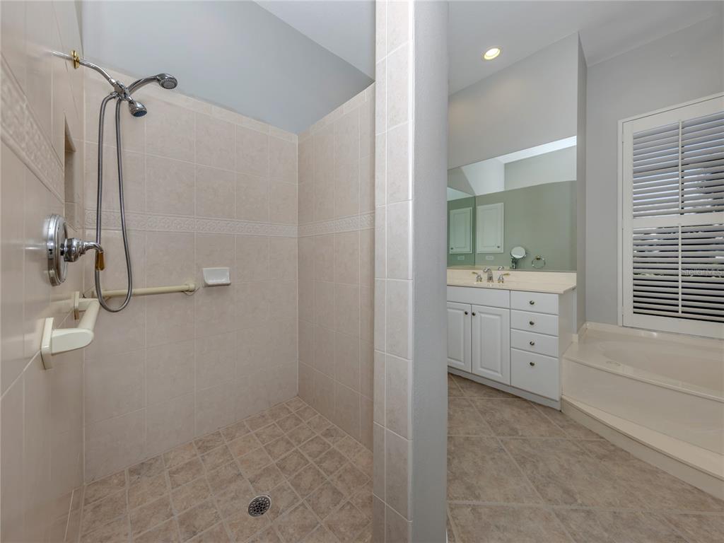 406 Trenwick Lane Venice, FL 34293 - Photo 20 of 60 a bathroom with a double vanity sink a toilet and shower