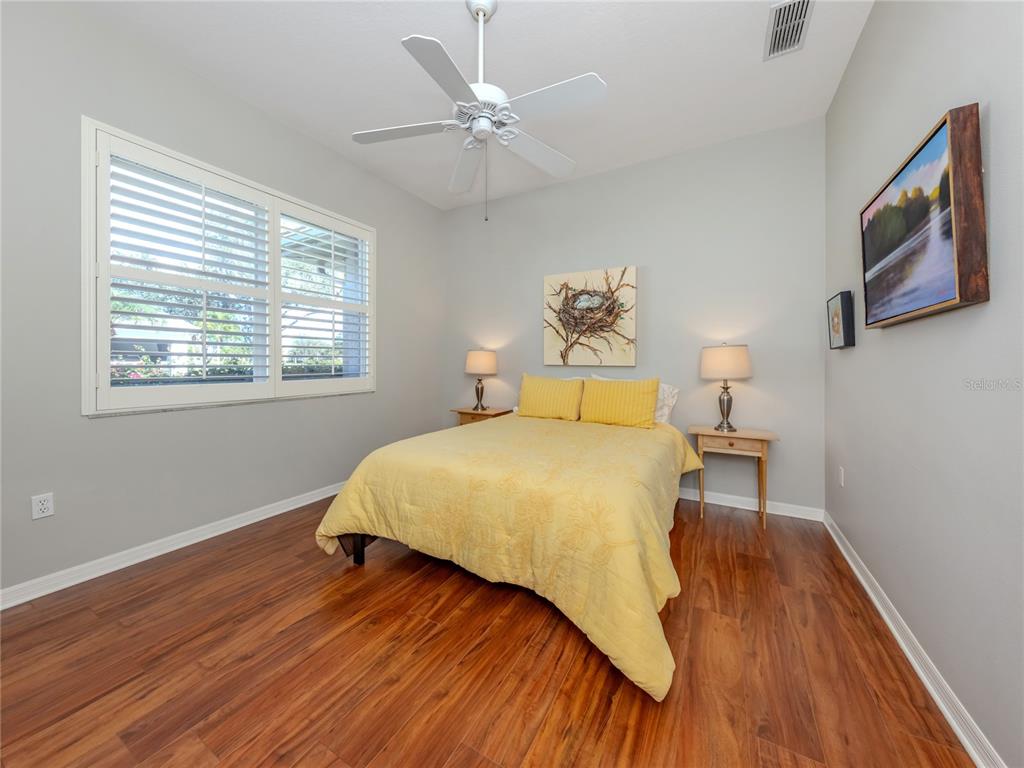 406 Trenwick Lane Venice, FL 34293 - Photo 21 of 60 a bedroom with a bed and a window
