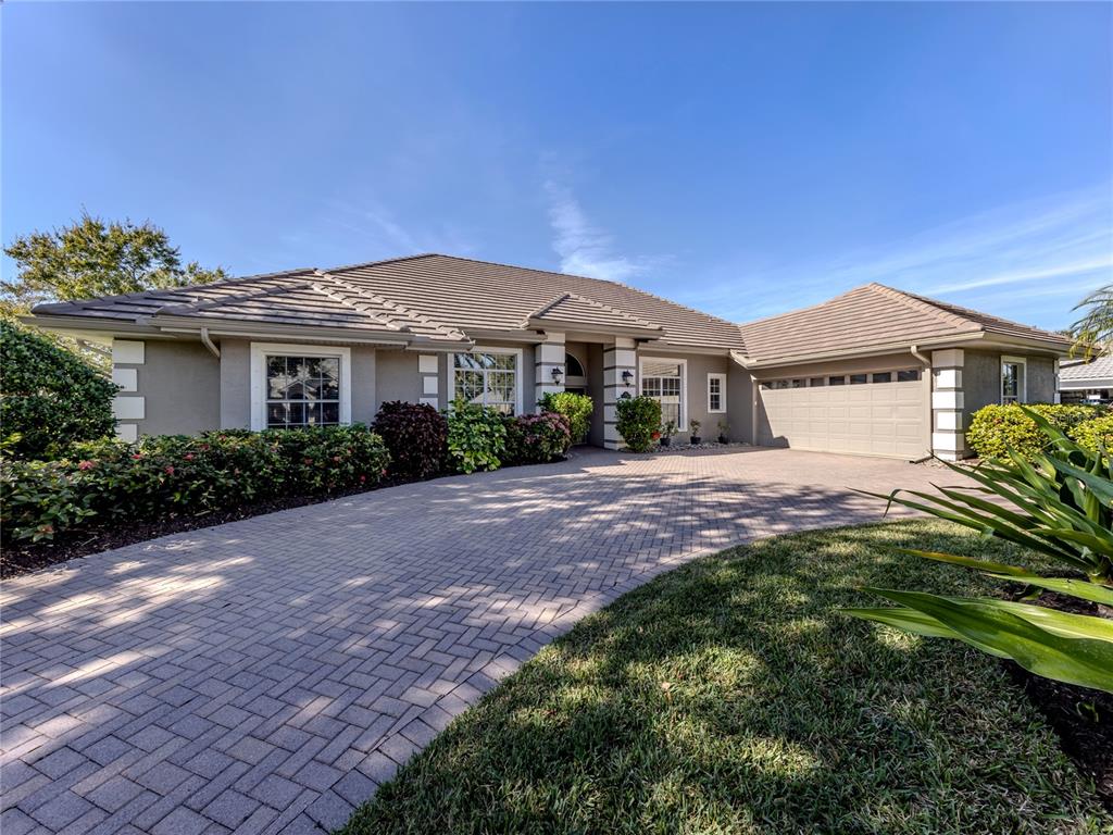 406 Trenwick Lane Venice, FL 34293 - Photo 37 of 60 a front view of a house with a garden
