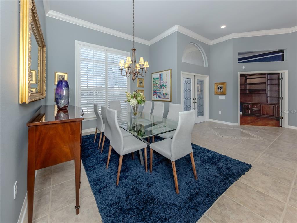406 Trenwick Lane Venice, FL 34293 - Photo 5 of 60 a view of a dining room with furniture wooden floor and chandelier