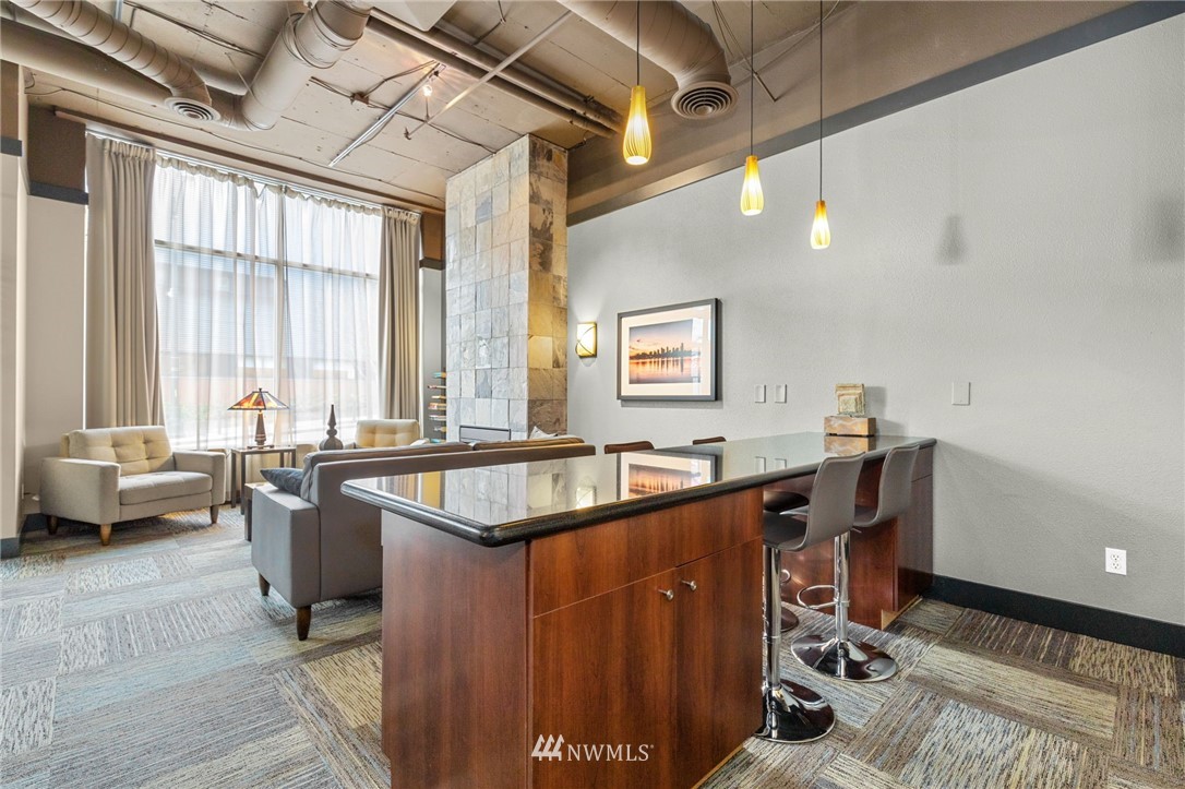 108 5th Avenue South, Unit 710 Seattle, WA 98104 - Photo 14 of 22 a dining hall with stainless steel appliances granite countertop a sink a counter space and a window