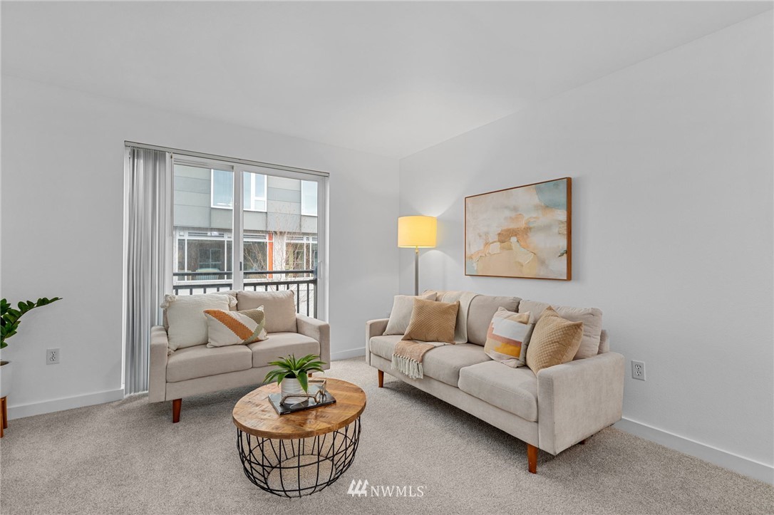 108 5th Avenue South, Unit 710 Seattle, WA 98104 - Photo 4 of 22 a living room with furniture and a window