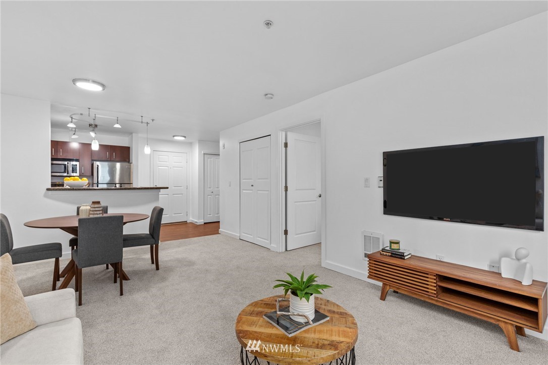 108 5th Avenue South, Unit 710 Seattle, WA 98104 - Photo 6 of 22 a living room with furniture and a flat screen tv